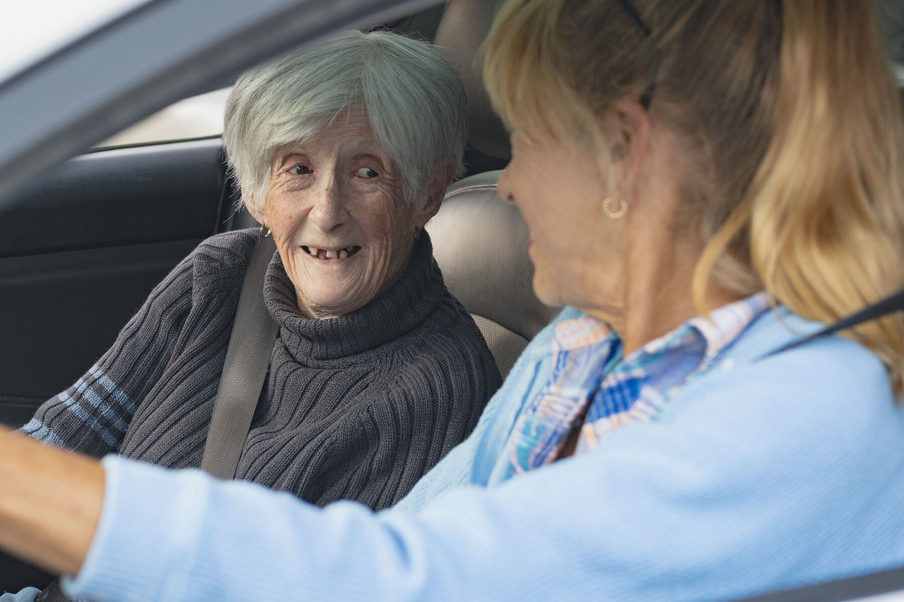 Transportation: a client smiling from the passenger seat
